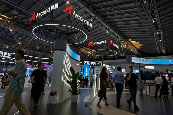 FILE - People visit the Ascend AI exhibition booth by Huawei during the 2024 The World Artificial Intelligence Conference (WAIC) & High-Level Meeting on Global AI Governance with the theme "Governing AI for Good and for All" at the Shanghai Expo Center Multifunction Hall in Shanghai China on July 4, 2024. (AP Photo/Andy Wong, File)