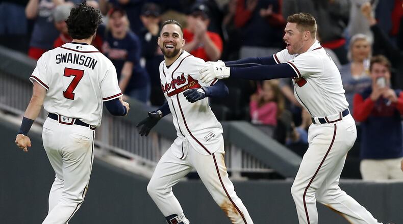 Ender Inciarte, center, celebrates his game-winning squeeze bunt against the Mets with Dansby Swanson and Freddie Freeman. (Mike Zarrilli/Getty Images)