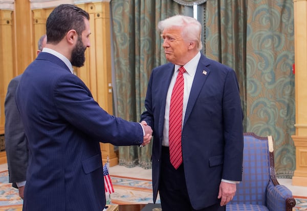 In this photo released by the Saudi Royal Palace, President Donald Trump, right, shakes hands with Syria's interim President Ahmad al-Sharaa, in Riyadh, Saudi Arabia, May 14, 2025. (Bandar Aljaloud/Saudi Royal Palace via AP)