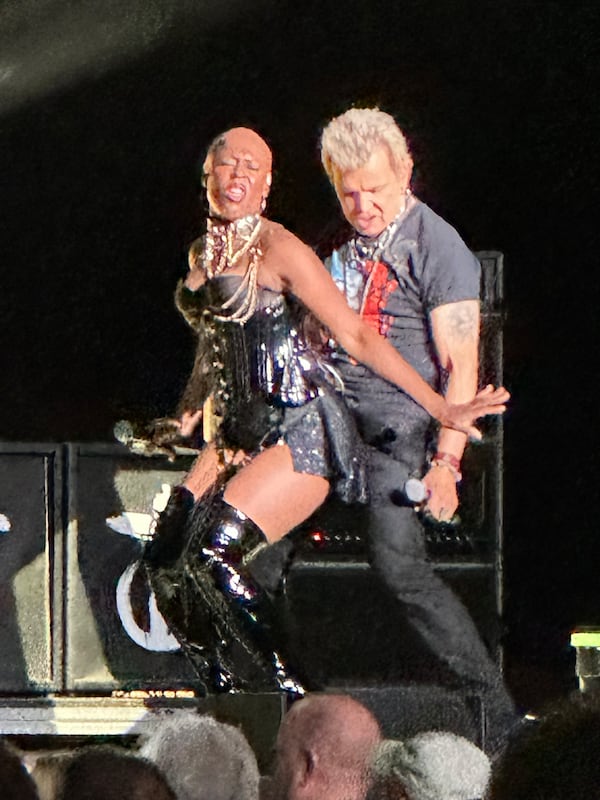 Billy Idol dances with backup singer Kitten Kuroi during "Love Don't Live Here Anymore" at Friday's show in Alpharetta. (Rodney Ho/AJC)