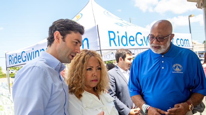 Senator Jon Ossoff, from left, and Congresswoman Lucy McBath talk before greeting Georgia State House Representative Dewey McClain, right, at the Gwinnett County celebration of a $20 million grant Monday, July 24, 2023 awarded by the federal government to transform the transit center just west of Gwinnett Place Mall.  (Jenni Girtman for The Atlanta Journal-Constitution)