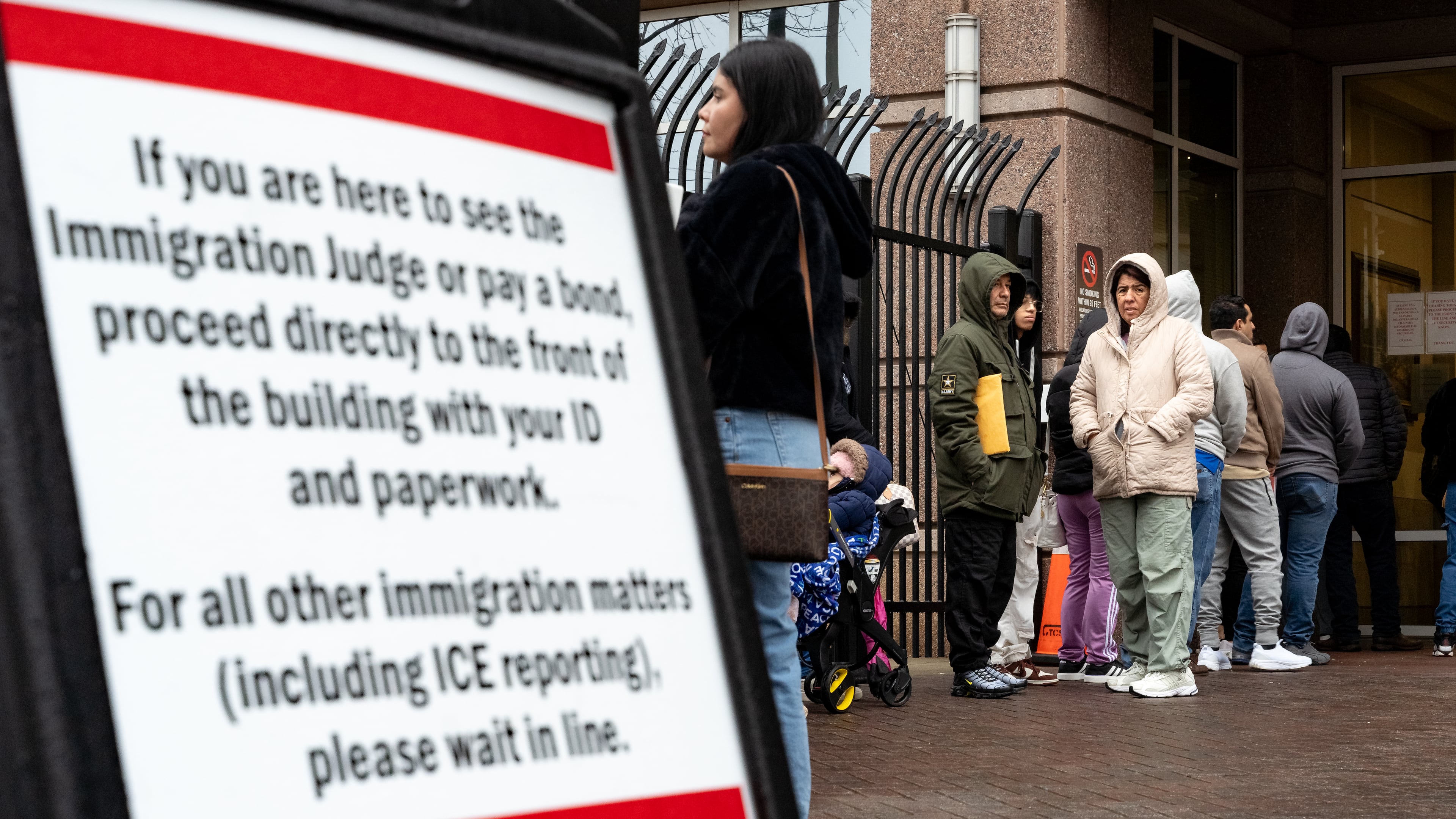 People line up outside the federal building in Atlanta that houses an immigration court and ICE office. Several cases in the court are at the center of a disciplinary proceeding against Norcross immigration lawyer Christopher Taylor. (Ben Hendren/AJC 2025)