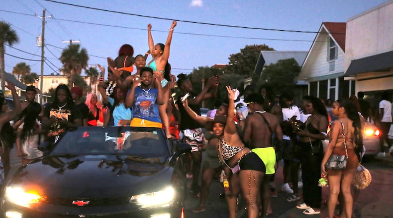 Longtime residents of Tybee Island say city officials have sought since 1991 to end Orange Crush, an annual, unsanctioned spring break party frequented by students of historically Black colleges and universities across the Southeast and other young adults. Extra steps are being taken this year after 111,000 attended last year's event on the 3-square-mile island. SAVANNAHNOW.COM FILE PHOTO
People dancing in the street and on cars as the sun goes down on Tybee Islands Orange Crush party on Saturday, April 22.
RJ Smith/ Savannah Morning News