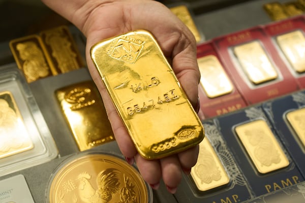 Sam Nguyen shows a gold bar at her shop in the St. Vincent Jewelry Center in the Jewelry District of Los Angeles, Wednesday, April 30, 2025. (AP Photo/Jae C. Hong)