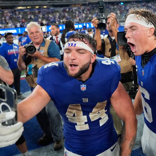 New York Giants running back Cam Skattebo (44) and quarterback Jaxson Dart (6) react with a cell phone following an NFL football game against the Dallas Cowboys Sunday, Sept. 13, 2026, in East Rutherford, N.J. (AP Photo/Yuki Iwamura)