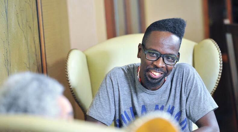 September 15, 2016 Atlanta - Atlanta based artist Fahamu Pecou reacts as he listens to filmmaker, sculptor and provocateur Camille Billops (foreground) at Emory University Conference Center Hotel on Thursday, September 15, 2016. Both have made careers exploring black identity and representation in art. Pecou’s work is in the permanent collection of the new Smithsonian African American musuem, Billops’ work is taught in colleges around the country. HYOSUB SHIN / HSHIN@AJC.COM