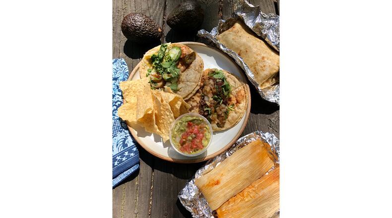 A takeout spread from Bell Street Burritos includes a grilled pork and green chili burrito; a chicken and a pork tamale; guacamole and chips; and a shrimp and a ground beef taco. You may also buy ingredients like avocados from the online market. CONTRIBUTED BY WENDELL BROCK