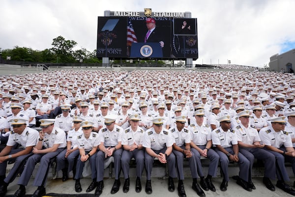 Cadets listen as President Donald Trump, seen on screen, speaks to United States Military Academy graduating cadets during commencement ceremonies in West Point, N.Y., Saturday, May 24, 2025. (AP Photo/Manuel Balce Ceneta)