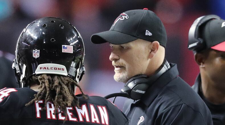 Falcons running back Devonta Freeman gets a pat on the back from head coach Dan Quinn after his second of three touchdown runs during the second quarter of Sunday's 41-13 win over San Francisco at the Georgia Dome. Freeman rushed for 139 yards. (Curtis Compton/ccompton@ajc.com)
