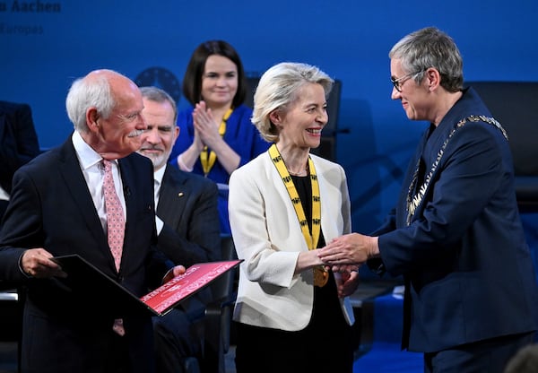European Commission President Ursula von der Leyen, center, receives the Charlemagne Prize in Aachen, Germany, Thursday, May 29, 2025. (Federico Gambarini/DPA via AP, Pool)