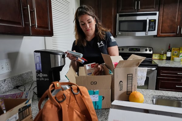 Shea Giagnorio packs belongings in her apartment days after getting fired from her job with the Administration for Children and Families, Monday, April 14, 2025, in Overland Park, Kan. (AP Photo/Charlie Riedel)