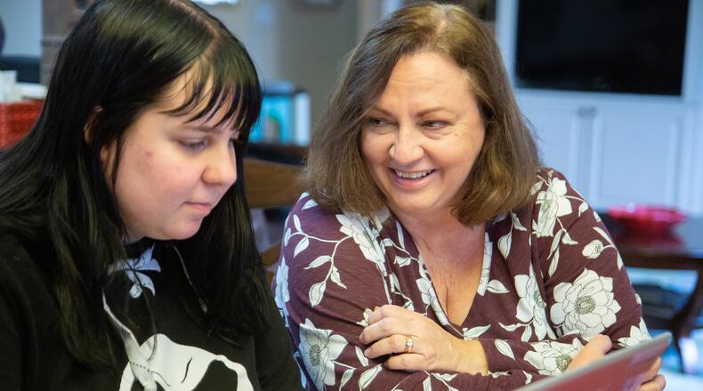 Stephanie Fuhrmannek helps her daughter Emily with her math homework at their Dacula home on January 8, 2020.  STEVE SCHAEFER FOR THE ATLANTA JOURNAL-CONSTITUTION