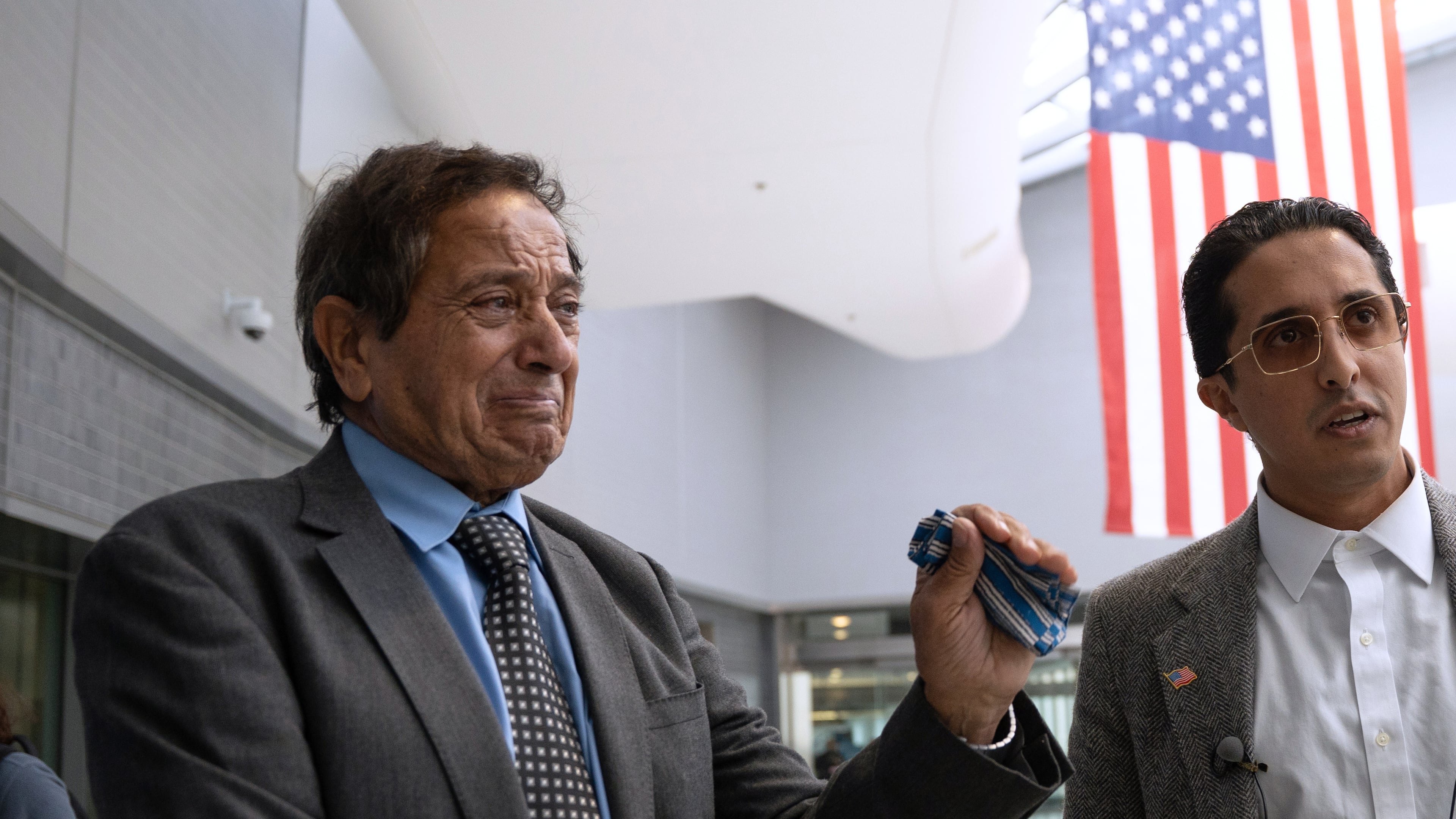 Father-son duo Saad and Ibrahim Almadi speak to reporters after entering the Philadelphia International Airport International Arrivals Hall on Thursday, Nov. 20, 2025, in Philadelphia. (AP Photo/Mingson Lau)
