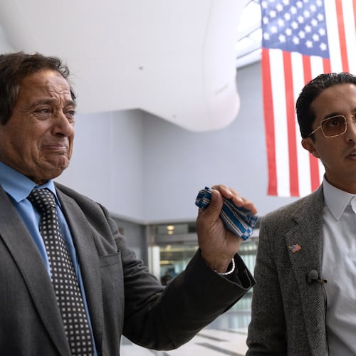 Father-son duo Saad and Ibrahim Almadi speak to reporters after entering the Philadelphia International Airport International Arrivals Hall on Thursday, Nov. 20, 2025, in Philadelphia. (AP Photo/Mingson Lau)