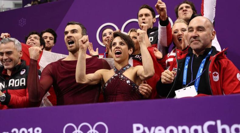 Pairs figure skater Meagan Duhamel, center, and her partner, Eric Radford, of Canada react to their score after competing in the Figure Skating Team Event Pairs Free Skating on day two of the PyeongChang 2018 Winter Olympic Games at Gangneung Ice Arena on February 11, 2018 in Gangneung, South Korea. Their performance helped secure the gold for their team.