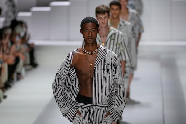 Models wear creations as part of the men's Dolce & Gabbana Spring-Summer 2026 collection, that was presented in Milan, Italy, Saturday, June 21, 2025. (AP Photo/Luca Bruno)