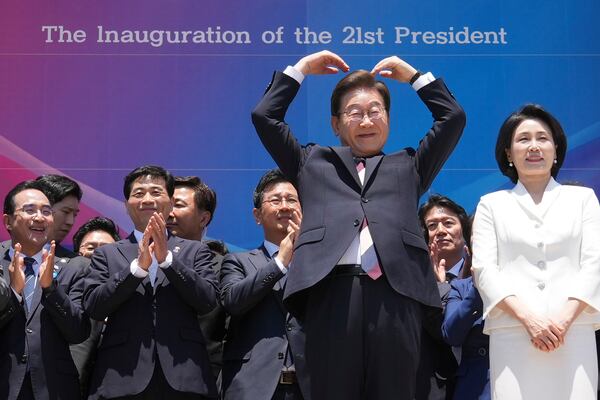South Korean new President Lee Jae-myung, front left, and his wife Kim Hea Kyung greet to the people after attending the presidential inauguration at the National Assembly in Seoul, South Korea, Wednesday, June 4, 2025. (AP Photo/Lee Jin-man, Pool)