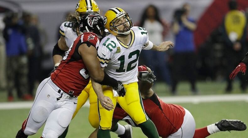 Atlanta Falcons defensive end Dwight Freeney (93) hits Green Bay Packers' Aaron Rodgers after he throws during the second half of the NFL football NFC championship game Sunday, Jan. 22, 2017, in Atlanta. (AP Photo/David J. Phillip)