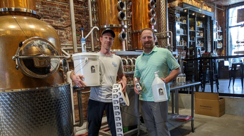 Brothers Jeff (left) and Craig Moore of Atlanta’s Old Fourth Distillery found themselves in a surprising new line, pivoting from distilled spirits to hand sanitizer. CONTRIBUTED BY JEFF MOORE