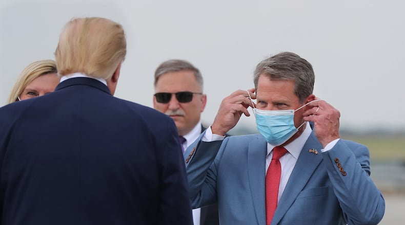 Georgia Gov. Brian Kemp, right, greets President Donald Trump as he visits Georgia to talk about an infrastructure overhaul at Hartsfield-Jackson International Airport in Atlanta on July 15, 2020. (Curtis Compton/Atlanta Journal-Constitution/TNS)