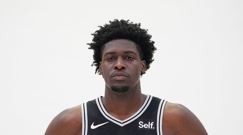 FILE - San Antonio Spurs center Charles Bediako poses for photos during an NBA basketball media day in San Antonio, Oct. 2, 2023. (AP Photo/Eric Gay, File)
