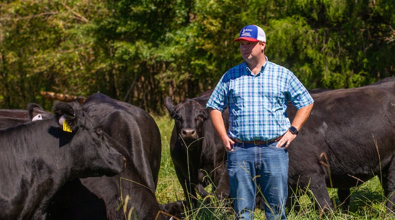 Cleve Jackson stands near some of his cows on his Cave Spring ranch Friday, September 24, 2021. STEVE SCHAEFER FOR THE ATLANTA JOURNAL-CONSTITUTION