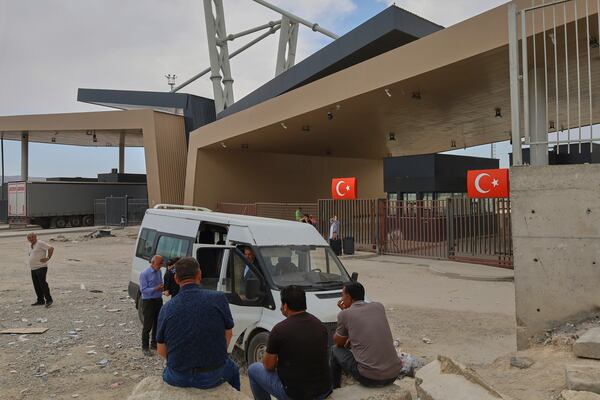 People wait after crossing from Iran into Turkey at Gurbulak Bazargan border post, in Gurbulak, Turkey, Monday, June 16, 2025. (AP Photo/Kadir Cesur)