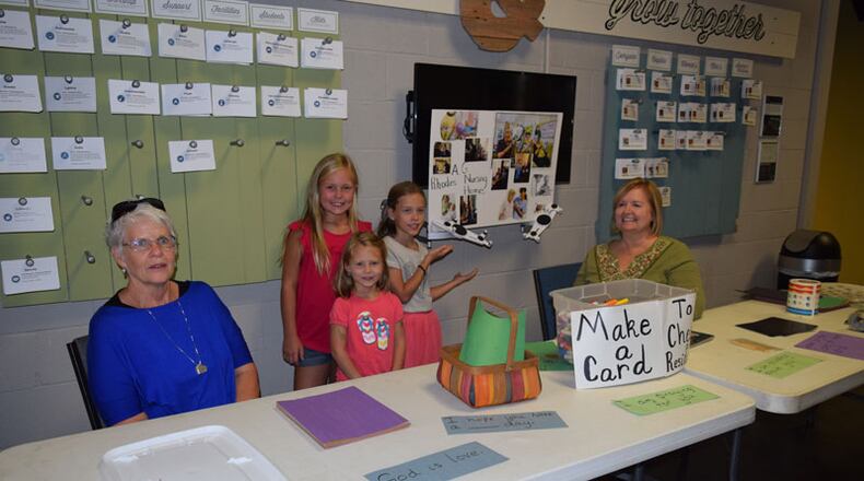 Kate Hollandsworth and volunteers encouraged people to write greetings cards for the seniors at A.G. Rhodes. Hollandsworth hosted a game night at her church to raise money for A.G. Rhodes, a nursing home in Monroe. The game night raised over $1,200 to support the activities and entertainment department of the nursing home. Contributed by Kids Boost.