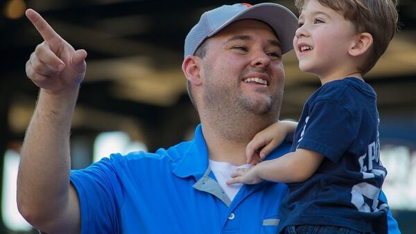 DETROIT, MI -  A dad points out to the field with his son before a MLB game between the Detroit Tigers and the Chicago White Sox at Comerica Park in Detroit, Michigan. 