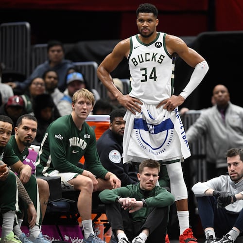 Milwaukee Bucks forward Giannis Antetokounmpo (34) watches the action while resting during the second half of an NBA basketball game against the Washington Wizards, Monday, Dec. 1, 2025, in Washington. (AP Photo/John McDonnell)