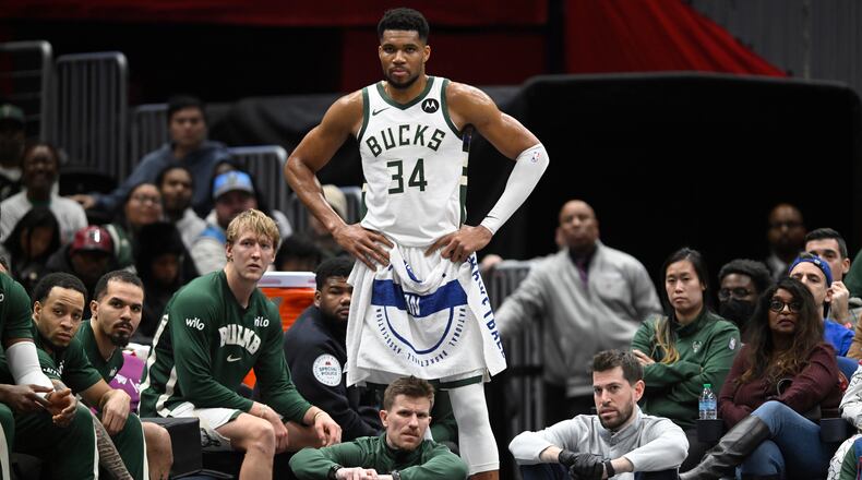 Milwaukee Bucks forward Giannis Antetokounmpo (34) watches the action while resting during the second half of an NBA basketball game against the Washington Wizards, Monday, Dec. 1, 2025, in Washington. (AP Photo/John McDonnell)