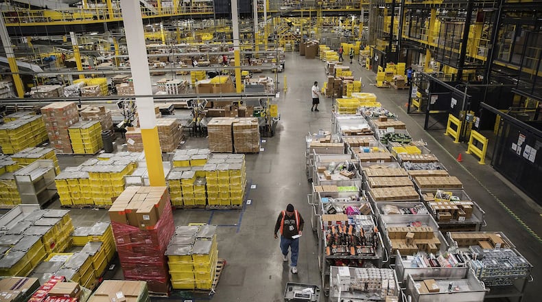 Employees filling online orders at an Amazon distribution center. (Bloomberg photo by Victor J. Blue)