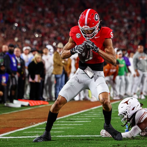 Georgia wide receiver Noah Thomas (5) scores a touchdown past Texas defensive back Kade Phillips (11) during the first half of an NCAA college football game, Saturday, Nov. 15, 2025, in Athens, Ga. (AP Photo/Colin Hubbard)