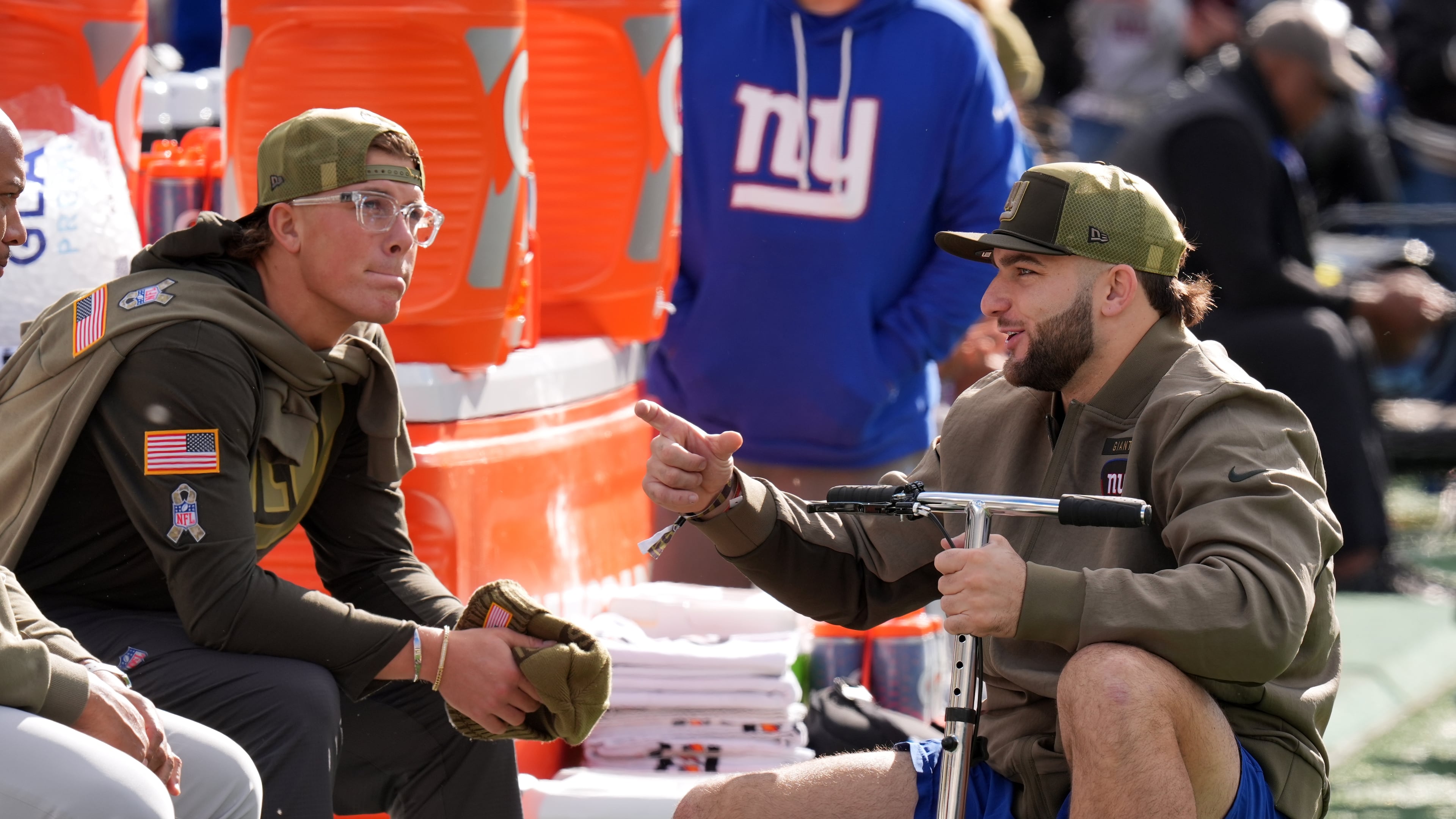 New York Giants' injured players Cam Skattebo and Jaxson Dart talk before an NFL football game against the Green Bay Packers Sunday, Nov. 16, 2025, in East Rutherford, N.J. (AP Photo/Seth Wenig)