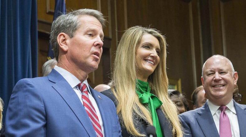 12/04/2019 — Atlanta, Georgia — Newly appointed U.S. Senator Kelly Loeffler (center) reacts as Georgia Gov. Brian Kemp (left) speaks during a press conference in his office at the Georgia State Capitol Building, Wednesday, December 4, 2019. Georgia Gov. Brian Kemp appointed Kelly Loeffler to the U.S. Senate to take the place of U.S. Senator Johnny Isakson, who is stepping down for health reasons. (ALYSSA POINTER/ALYSSA.POINTER@AJC.COM)