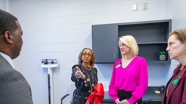 Lynne Meadows, Fulton County Schools' director of district health services, gives a tour of the private exam rooms at the opening of Fulton County’s first school-based health center at Banneker High School in College Park on Wednesday, Jan. 31, 2024. Fulton school board members Kristin McCabe and Katha Stuart are to the right. (Jenni Girtman for The Atlanta Journal-Constitution)