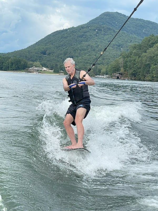 David Stockton, a pancreatic cancer patient, wakeboards on Lake Lure. He recently began treatment with a new drug, daraxonrasib. (Courtesy of Thatcher Townsend)