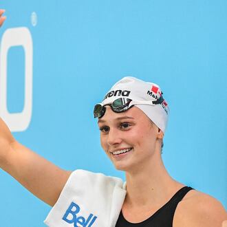 Summer McIntosh waves to fans after setting a new world in the women's 200m butterfly final at the Canadian Swimming Trials in Montreal, on Sunday, July 5, 2026. (Graham Hughes/The Canadian Press via AP)
