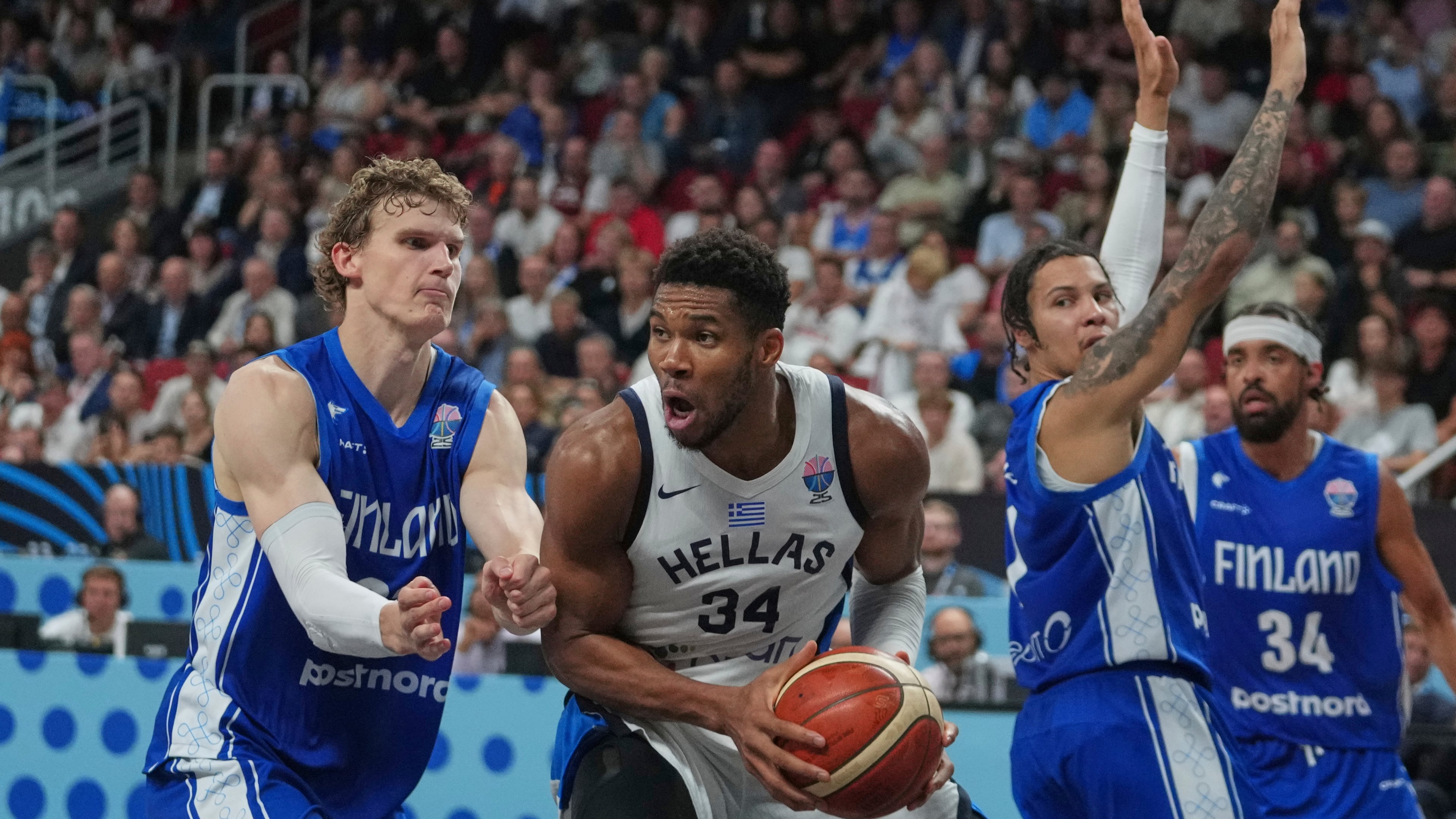 Finland's Lauri Markkanen, left, and Greece's Giannis Antetokounmpo in action during the Eurobasket, European Basketball Championship third place match between Greece and Finland at the Riga Arena in Riga, Latvia, Sunday, Sept. 14, 2025. (AP Photo/Sergei Grits)