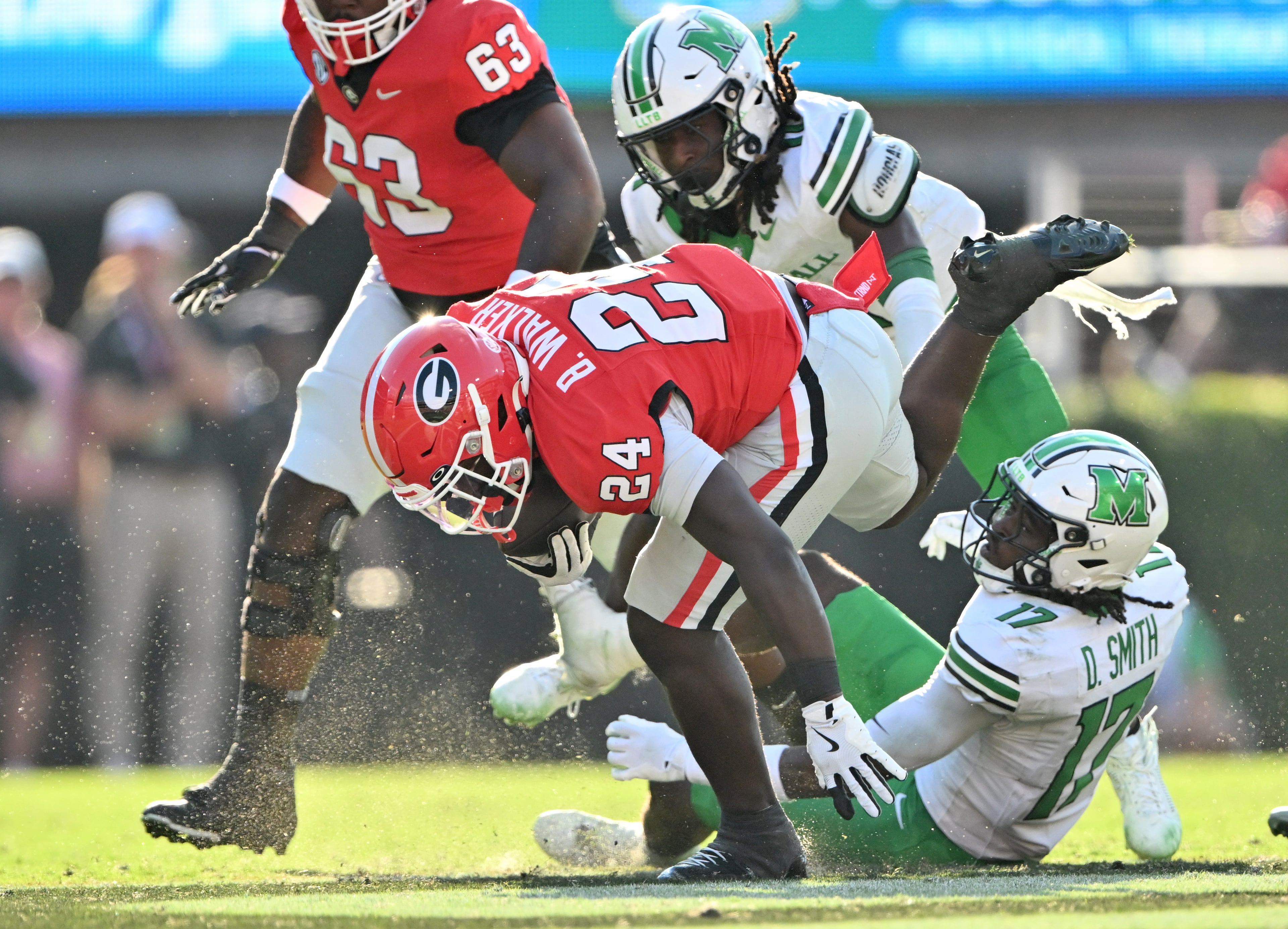 Georgia running back Bo Walker (24) breaks a tackle by Marshall safety Daytione Smith (17) during the second half in an NCAA football game at Sanford Stadium, Saturday, August 30, 2025, in Athens. Georgia won 45-7 over Marshall. (Hyosub Shin / AJC)