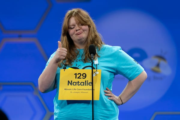 Natalie Mae Linthicum, 13, of St. Joseph, Mo.,gestures as she spells her word as she competes during the first preliminary round of the Scripps National Spelling Bee at the Gaylord National Resort & Convention Center, Tuesday, May 27, 2025, in Oxon Hill, Md. (AP Photo/Jose Luis Magana)