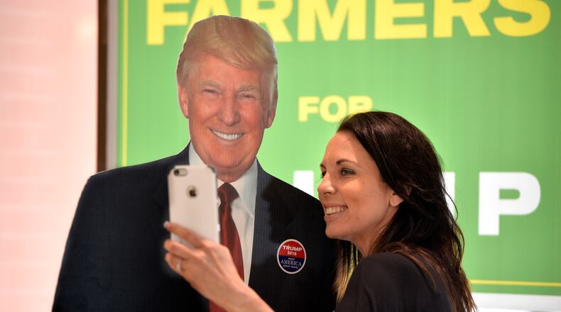 Ginny Ehrhart poses for a selfie with a life-size, cardboard cutout of Trump during the Georgia Republican Party State Convention in Augusta, June 3. (Michael Holahan / The Augusta Chronicle)