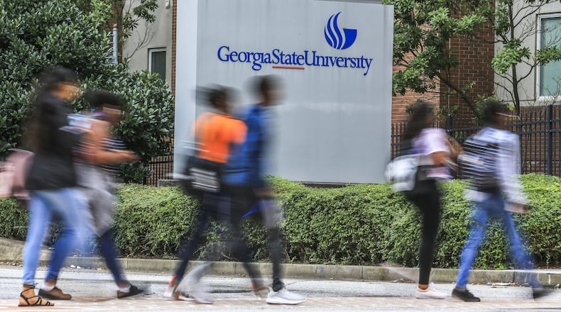 Georgia State University students cross Ellis Street at Piedmont Avenue on Monday Aug. 20, 2018. The university, which has more students than any school in Georgia, was one of several schools reporting record first-year student enrollment this fall.