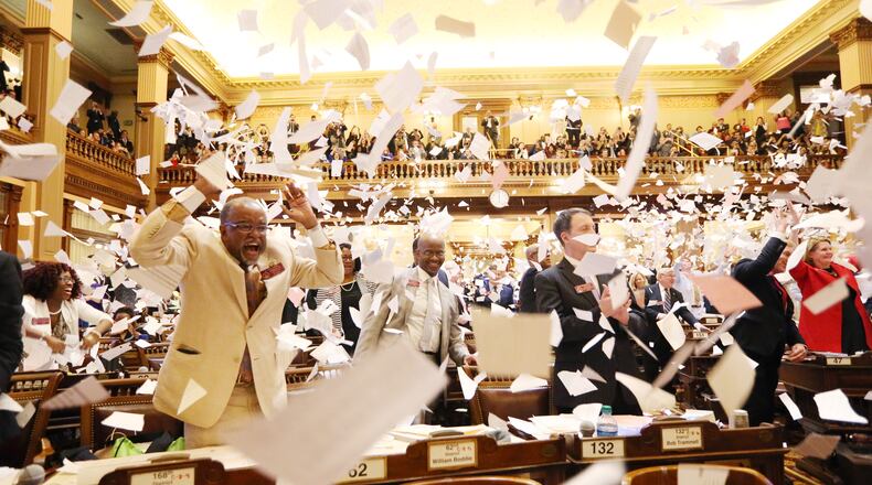 House members throw paper in the air to celebrate the end of the 2019 session of the Legislature at the Georgia State Capitol on Tuesday. EMILY HANEY, emily.haney@ajc.com