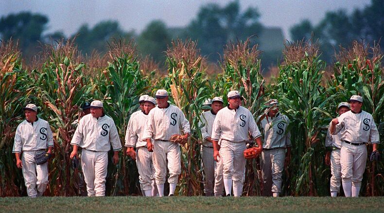 FILE - People portraying ghost players emerge from the cornfield at the "Field of Dreams" movie site in Dyersville, Iowa, on June 22, 1997. (AP Photo/Charlie Neibergall, File)