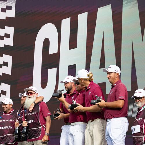Team champions captain Cameron Smith, Marc Leishman, Lucas Herbert and Travis Smyth, of Ripper GC, and their caddies celebrate onstage after their first-place win following the final round of the LIV Golf United Kingdom golf tournament Sunday, July 26, 2026, in Rocester, England. (Jon Ferrey/LIV Golf via AP)