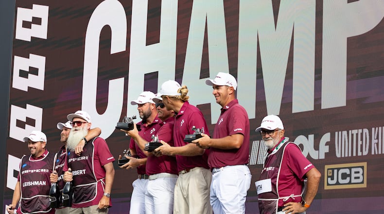 Team champions captain Cameron Smith, Marc Leishman, Lucas Herbert and Travis Smyth, of Ripper GC, and their caddies celebrate onstage after their first-place win following the final round of the LIV Golf United Kingdom golf tournament Sunday, July 26, 2026, in Rocester, England. (Jon Ferrey/LIV Golf via AP)