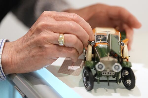 Mike Caltrider repairs a model part of the automobilia collection at The Rolls-Royce Foundation in Mechanicsburg, Pa., Saturday, April 5, 2025. (AP Photo/Matt Rourke)