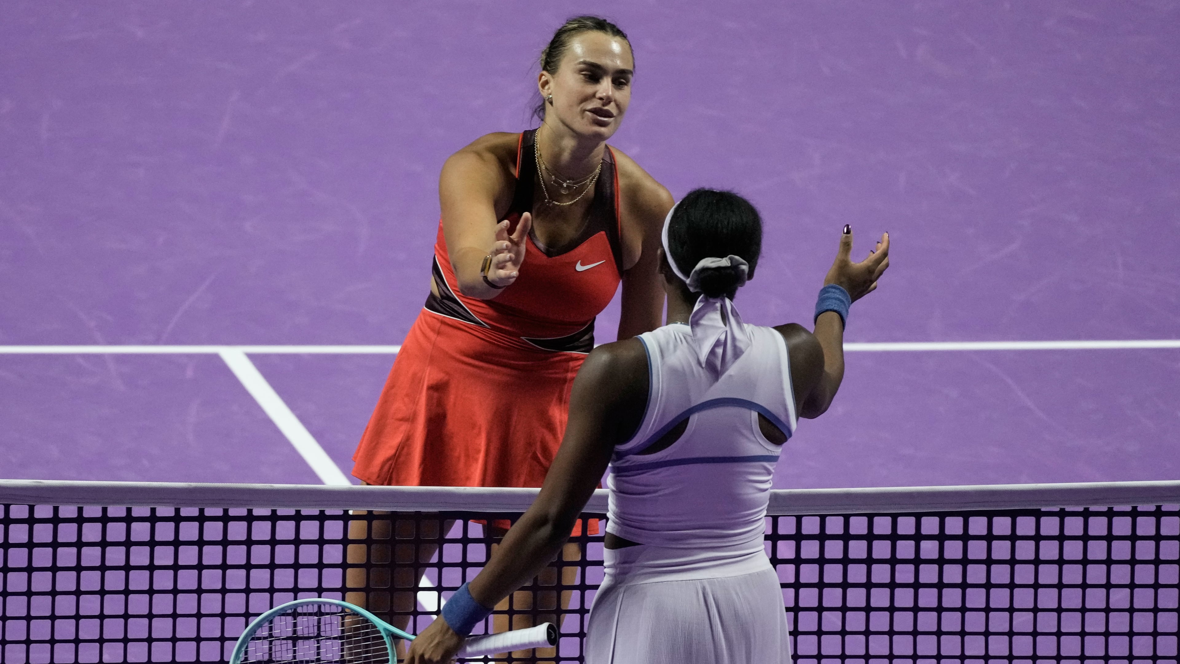 Aryna Sabalenka of Belarus, left, greets her opponent Coco Gauff of the United States after winning the women's singles match at the WTA tennis finals in Riyadh, Saudi Arabia, Thursday, Nov. 6, 2025. (AP Photo/Fatima Shbair)