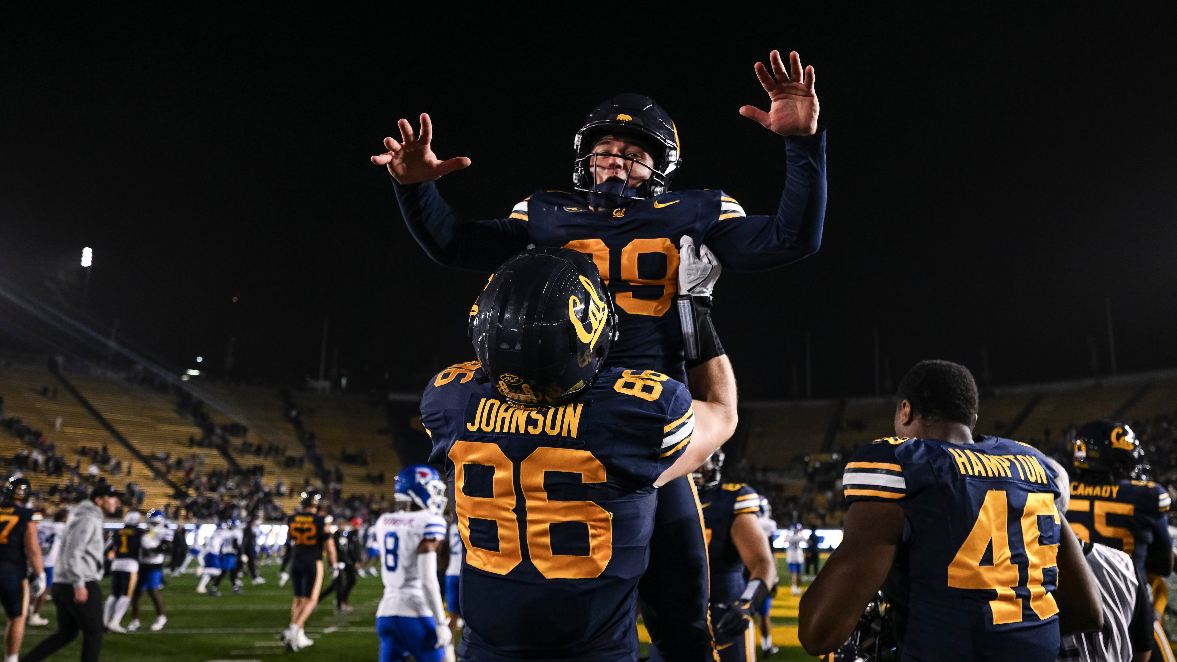 California tight end Jeffrey Johnson (86) lifts outside linebacker Michael Cooley after defeating SMU in a NCAA college football game, Saturday, Nov. 29, 2025, in Berkeley, Calif. (AP Photo/Justine Willard)